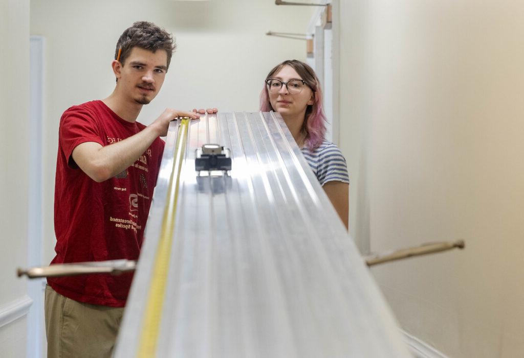 Gregory Wietrzykowski '26, Alaina Snider '27 roll a toy car down a ramp